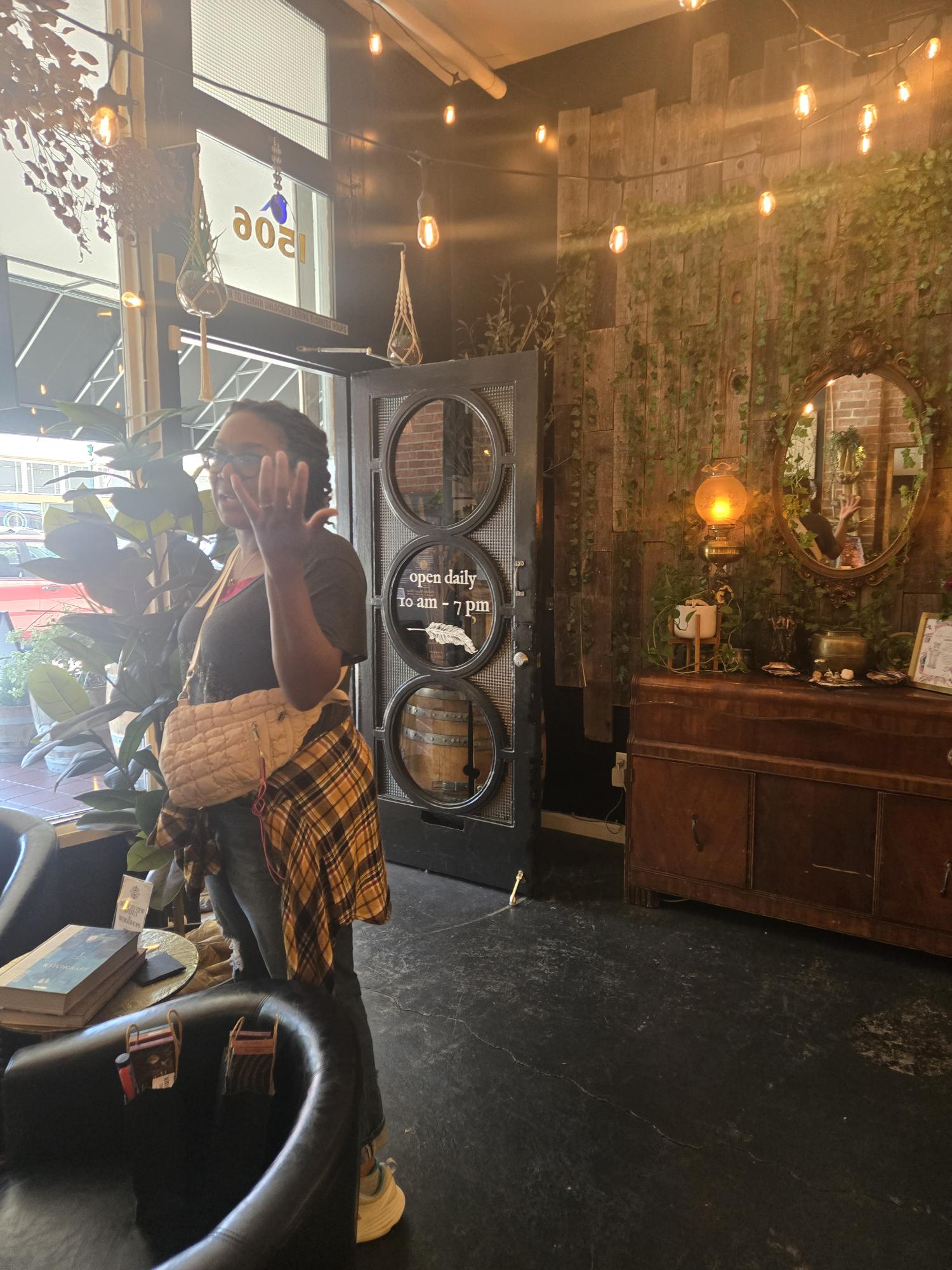 Charisse leading a tour group at a Bay Area crystal shop entrance